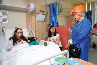Queen Elizabeth speaks to 12-year-old Amy Barlow and her mother, Kathy, during a May 25 visit to the Royal Manchester Children’s Hospital. Amy was one of dozens wounded in the May 22 Manchester bombing.