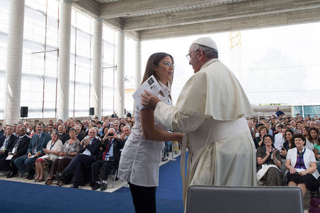 Pope Francis greets a woman during his visit with Giovanni Traettino, a Protestant pastor and his friend, in Caserta, Italy, July 28. Pope Francis said he knew people would be shocked that he would make such a trip outside of Rome to visit a group of Pen tecostals, &quot;but I went to visit my friends.&quot;