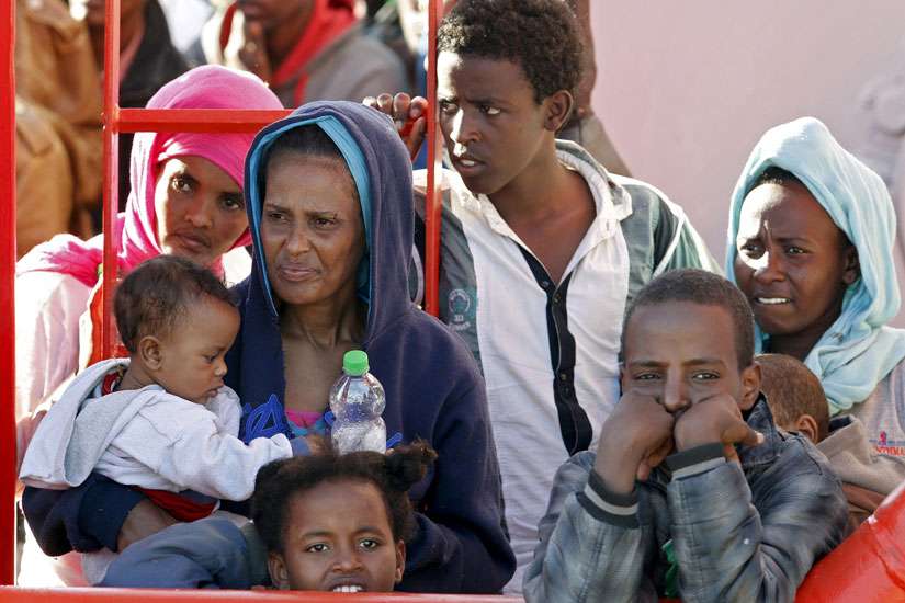 Migrants wait to disembark from a tug boat in the Sicilian harbour of Pozzallo May 4. Pope Francis said that allowing migrants to die in boats is an “attack on life,” among others like abortion, euthanasia, war and terrorism.