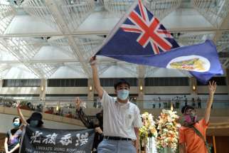 A pro-democracy demonstrator waves the British colonial Hong Kong flag during a protest against new national security legislation in Hong Kong June 1, 2020.