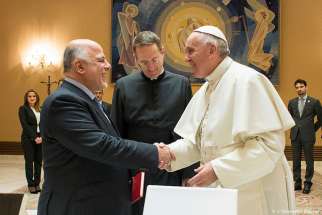 Pope Francis shakes hands with Iraqi Prime Minister Haider al-Abadi during a Feb. 10 meeting at the Vatican.