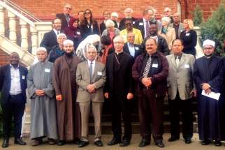 Archbishop Richard Smith and Catholic and Muslim leaders gather outside the church in St. Albert after a tour and visit. 
