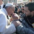 Pope Francis kisses a disabled man after spotting him in the crowd and having his popemobile stop as he rode through St. Peter’s Square March 19 ahead of his inaugural Mass at the Vatican.
