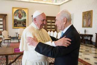 Pope Francis welcomes former Israeli President Shimon Peres during their meeting at the Vatican Sept. 4. The former president asked Pope Francis to head a parallel United Nations called the &quot;United Religions&quot; to counter religious extremism.