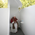 Pope Benedict XVI leaves a confessional after offering the sacrament of reconciliation to four World Youth Day volunteers in Madrid&#039;s main park Aug. 20. (CNS/L&#039;Osservatore Romano via Reuters)