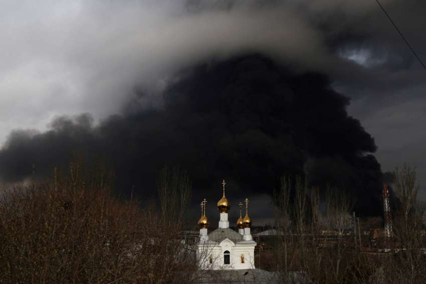 An Orthodox church is seen in front an oil refinery that caught fire following a missile attack near the port city of Odesa, Ukraine, April 3, 2022. The Ukrainian government said Dec. 1 it would sanction members of the Ukrainian Orthodox Church affiliated with the Moscow Patriarchate.