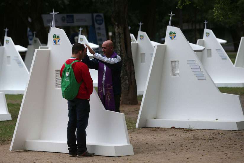 A pilgrim goes to confession during World Youth Day in Rio de Janeiro July 23, 2013. Pope Francis told priests at the Vatican March 12 that hearing confession should be awe-inspiring and an opportunity to look at their own life. 