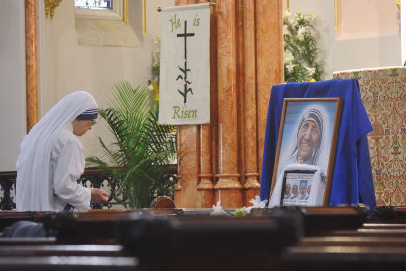 A member of the Missionaries of Charity honors the four sisters who were murdered in Yemen March 4 during a memorial Mass in New York City April 1.