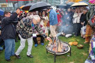 Jim Dumont adds some tobacco to the sacred fire that will burn for the duration of the seven-day Parliament of World Religions in Toronto, which has drawn delegates from over 70 countries.