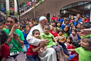 Pope Francis is pictured with youths at a home for former street children in Manila, Philippines, Jan. 16.