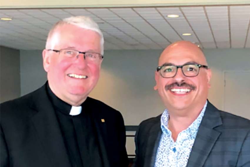 Rocco Gizzarelli, the retiring executive director of Hamilton’s Catholic Children’s Aid, right, with Hamilton Bishop Douglas Crosby.