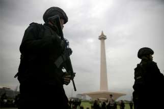 Armed police stand guard during a Dec. 21, 2017, ceremony ahead of the Christmas and New Year celebrations in Jakarta, Indonesia. Nearly 160,000 security personnel will be deployed to try to make upcoming Christmas and New Year celebrations in Indonesia safe, according to a police official.