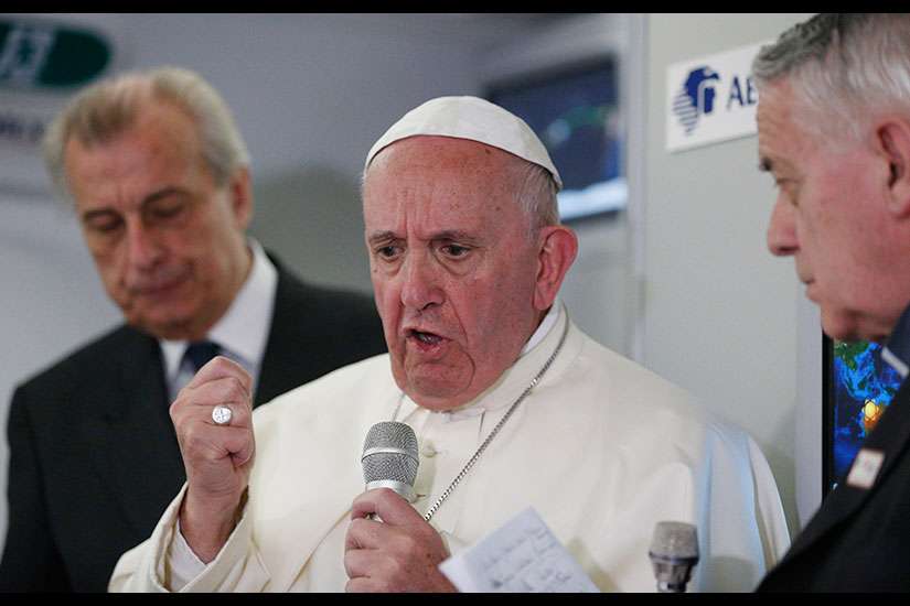 Pope Francis answers questions from journalists aboard his flight from Ciudad Juarez, Mexico, to Rome Feb. 17.