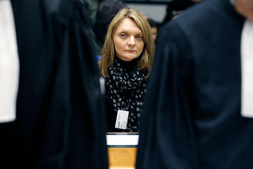 Rachel Lambert, the wife of Vincent Lambert, sits behind lawyers as she waits for the start of a hearing concerning the case of her husband at the European Court of Human Rights in Strasbourg, France, in this Jan. 7, 2015, file photo. Vincent Lambert, 42, a quadriplegic since an automobile accident in 2008, has been on a feeding tube at a hospital in Reims. The hospital has ordered his food and water be removed April 19.