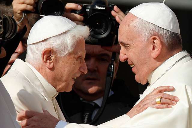 Pope Francis greets emeritus Pope Benedict XVI during an encounter for the elderly in St. Peter&#039;s Square at the Vatican Sept. 28.