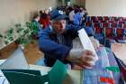 A man casts his ballot during a referendum in the city of Melitopol, Ukraine, Sept. 26, 2022.