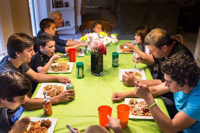 A large family is pictured eating dinner together in late May at their St. Louis home. A family that chooses to watch TV or play with their smartphones rather than talk at the dinner table is &quot;hardly a family,&quot; Pope Francis said.
