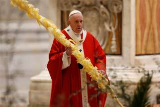 Pope Francis holds palm fronds celebrates Palm Sunday Mass in St. Peter&#039;s Basilica at the Vatican April 5, 2020. The Mass was celebrated without the presence of the public as Italy battles the coronavirus.