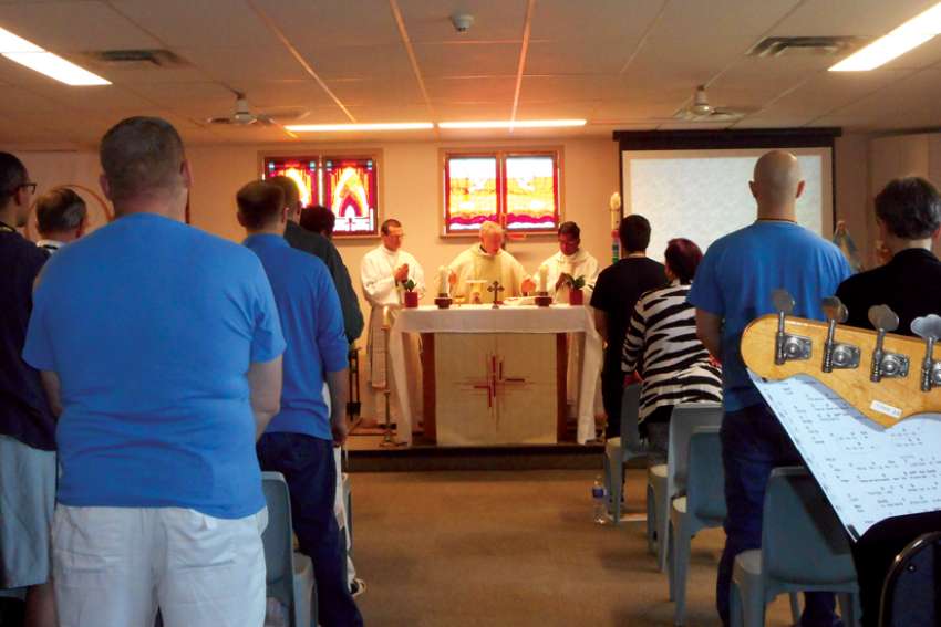 Vancouver Archbishop J. Michael Miller celebrates Mass with inmates at a B.C. institution.