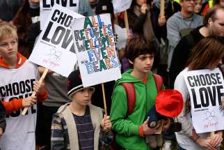 Young demonstrators gather outside Parliament in London Oct. 24 to call for more child refugees to be allowed asylum and safe passage to the United Kingdom. 