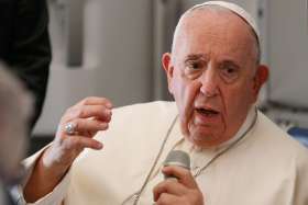 Pope Francis answers questions from journalists aboard the flight from Juba, South Sudan, to Rome Feb. 5, 2023.