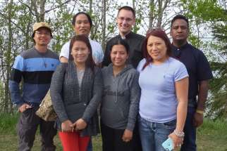 Catholics from St. John the Baptist Church who escaped the Fort McMurray wildfire in Alberta are pictured in Lac La Biche May 7. Back row from left are Leo Ganancial, Gary Agarin, Fathers Andrew Schoenberger and Prabhakar Kommareddy. Front row are Norie Sanchez, Shiela Ganancial and Cindy Julapton.