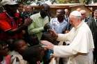 Pope Francis greets children as he visits a refugee camp in Bangui, Central African Republic, Nov. 29.