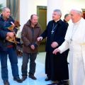 Pope Francis talks with three men Dec. 17 who live on the streets near the Vatican. As part of a low-key celebration of his 77th birthday, the pope celebrated morning Mass and had breakfast with the men.