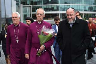 Anglican Archbishop Justin Welby of Canterbury, centre, attends a June 5 vigil with Chief Rabbi Ephraim Mirvis for the victims of the London Bridge terror attacks.