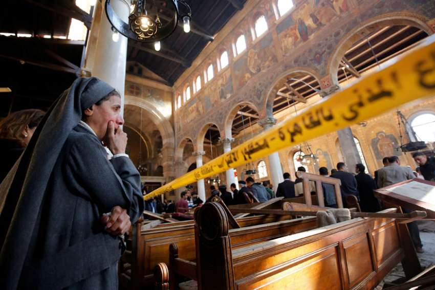 A nun cries as she stands inside St. Mark&#039;s Coptic Orthodox Cathedral Dec. 11 after an explosion inside the cathedral complex in Cairo. A bomb ripped through the complex, killing at least 25 people and wounding dozens, mostly women and children.