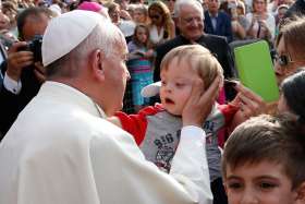 ope Francis greets a child during a gathering with young people in Piazza Vittorio in Turin, Italy, June 21.