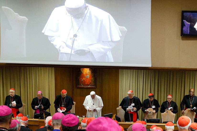 Pope Francis leads prayer in the synod hall at the Synod of Bishops on the Family.