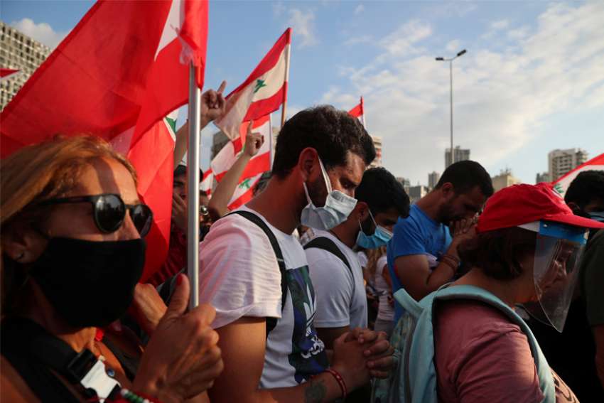 Demonstrators pray during a moment of silence as they take part in protests near the site of the blast at the Beirut&#039;s port area Aug. 11, 2020.