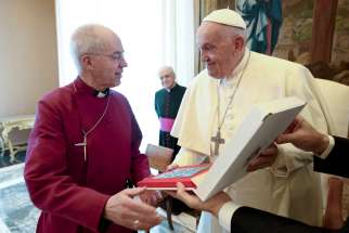 Pope Francis gives a gift to Anglican Archbishop Justin Welby of Canterbury, spiritual leader of the Anglican Communion, during a meeting with Anglican primates in the Apostolic Palace at the Vatican May 2, 2024.