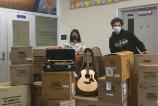 St. Aloysius Gonzaga music teacher Julia Jung, left, with Arkells’ lead singer Max Kerman and a shipment of musical instruments from the Nick Nurse Foundation for the Mississauga, Ont., school.