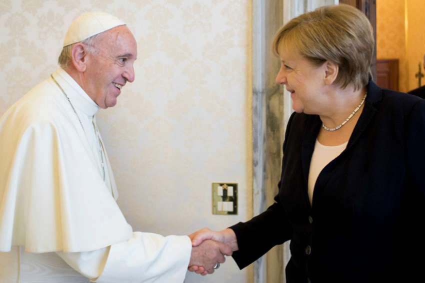 Pope Francis shakes hands with German Chancellor Angela Merkel at the Vatican June 17.