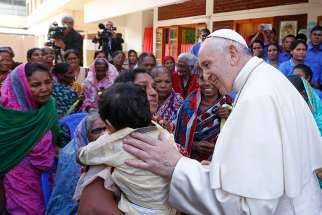 Pope Francis greets people as he visits the Mother Teresa House in the Tejgaon neighborhood in Dhaka, Bangladesh, Dec. 2.