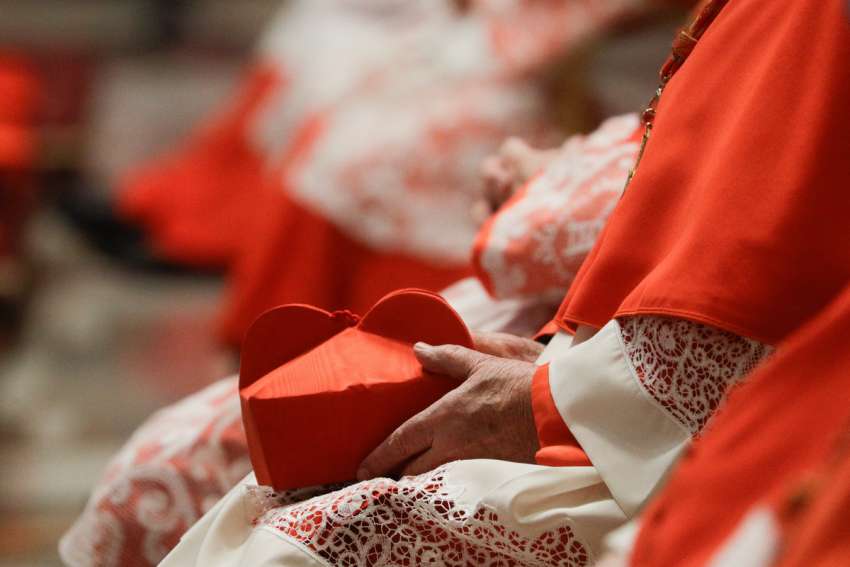 A cardinal holds his biretta as Pope Francis celebrates Mass with new cardinals in St. Peter&#039;s Basilica at the Vatican Nov. 29, 2020. Two U.S. prelates have recently traded what one called some &quot;strong words&quot; in the media, debating the reception of holy Communion, sexual sin, pastoral outreach to marginalized Catholics and allegations of heresy among church leadership.