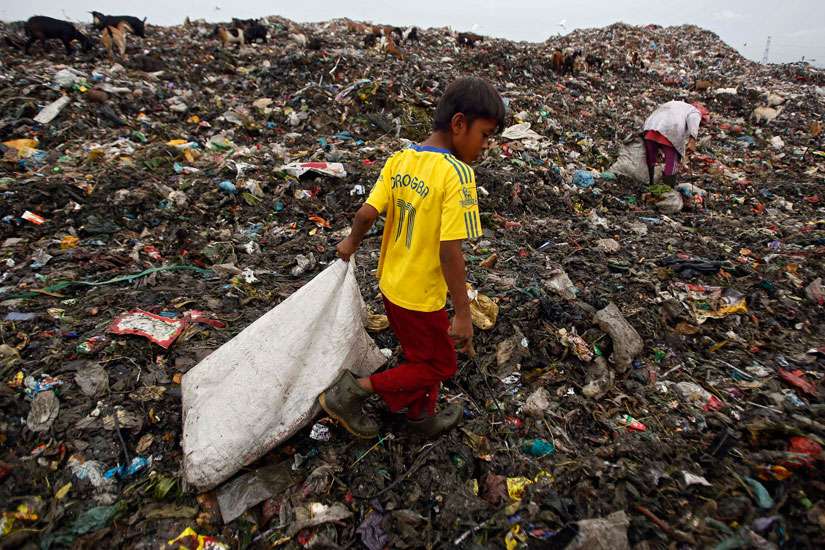 A boy collects recyclable materials at a dumpsite in Medan, Indonesia, Nov. 30. The U.N. climate change conference, known as the COP21 summit, runs from Nov. 30-Dec. 11 near Paris. 