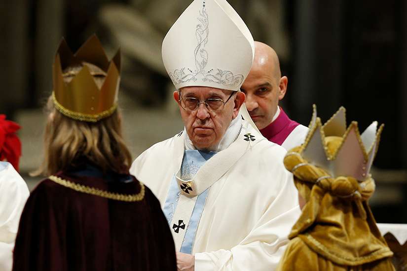  Pope Francis accepts offertory gifts from children dressed as the Three Kings during Mass marking the feast of Mary, Mother of God, in St. Peter&#039;s Basilica at the Vatican Jan. 1.