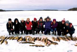 Students from the Rotaract Club at Queen’s University are pictured after net fishing on a trip to the Big Trout Lake First Nation to work with aboriginal youth.