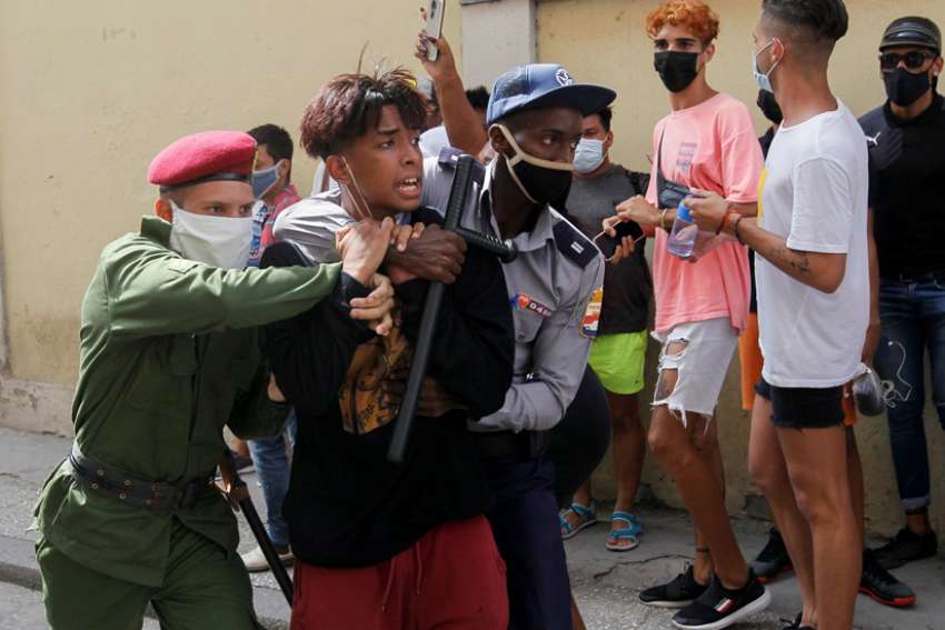 Police detain a person during protests in Havana July 11, 2021. Thousands of Cubans took to the streets to protest a lack of food and medicine as the country undergoes a grave economic crisis aggravated by the COVID-19 pandemic and U.S. sanctions.