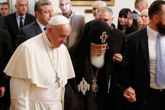 Pope Francis and Orthodox Patriarch Ilia II of Georgia arrive for a meeting at the patriarchal palace in Tbilisi, Georgia, Sept. 30.