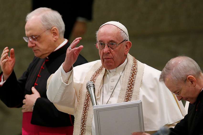 Pope Francis delivers his blessing during his general audience in Paul VI hall at the Vatican Feb. 13. 