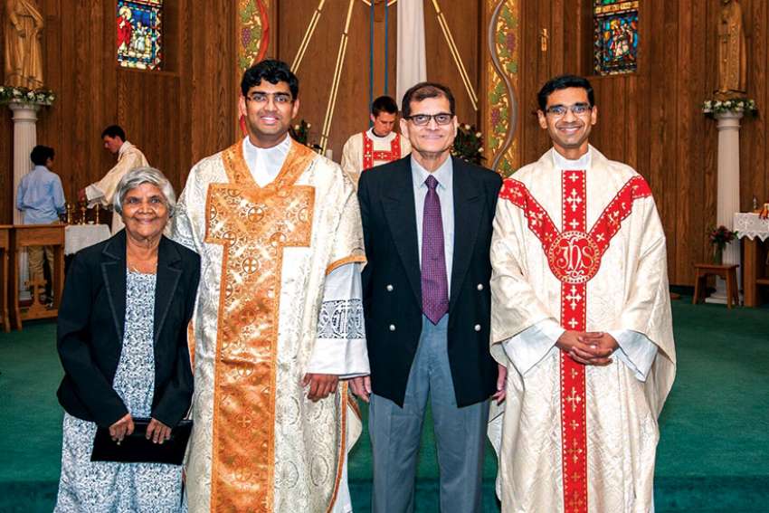 The Alemão brothers, Favin and Ryan, right, with their grandmother Crescencia Mergulhão Carvalho and father Felix at Favin’s First Mass at St. Edward the Confessor on May 14.