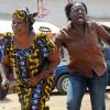 Women run from the scene of a bombing at St. Finbar Catholic Church in the Rayfield suburb of the Nigerian city of Jos March 11. The bomb detonated as worshippers attended the final Mass of the day, killing at least 10 people at the church in Jos, a city where thousands have died in the last decade in religious and ethnic violence.