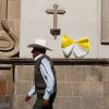 A man walks past a church decorated with a ribbon in the colors of the Vatican flag in Leon, Mexico, March 23. 