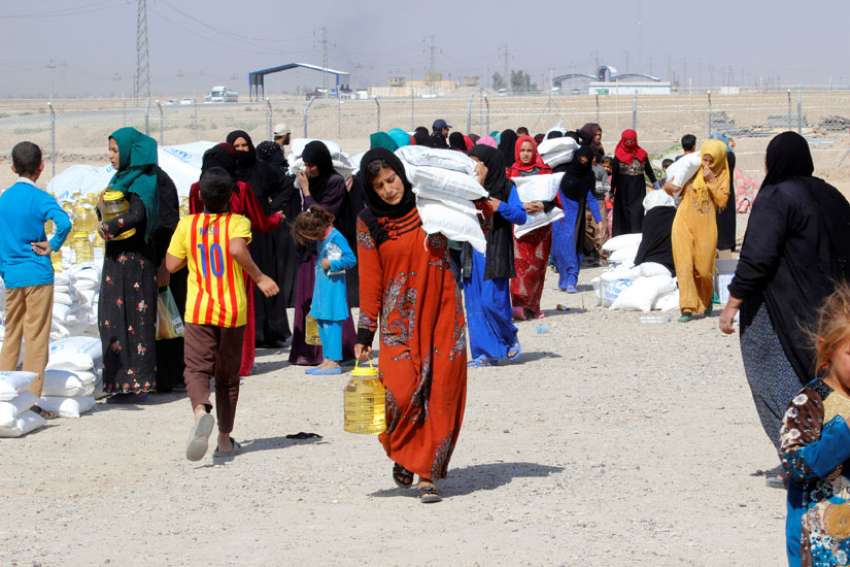 People who fled the Islamic State&#039;s strongholds of Hawija and Mosul receive aid Oct. 13 at a camp for displaced people in Daquq, Iraq. This summer, the U.N. said that as the Mosul crisis evolves, up to 13 million people throughout Iraq may need humanitarian aid by the year&#039;s end, far larger than the Syrian crisis.