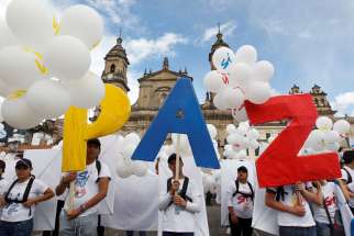 People form the word Peace outside the cathedral Sept. 26 in Bogota, Colombia. To chants of &quot;No more war,&quot; the Colombian government and Marxist rebels signed an agreement that day to end Latin America&#039;s last armed conflict.