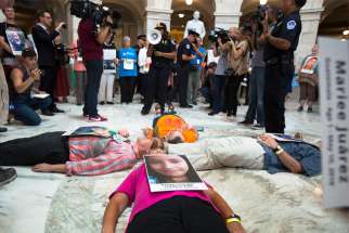 Catholic leaders and advocates lay on the floor of the Russell Senate Office Building in Washington July 18, 2019, to protest the Trump administration&#039;s handling of detained immigrant children.
